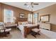 Spacious bedroom with carpet, a wood bed frame, many windows, and neutral paint at 3152 E San Pedro Ct, Gilbert, AZ 85234