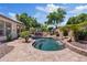 Inviting backyard pool with a waterfall feature, lush landscaping and brick pavers at 3152 E San Pedro Ct, Gilbert, AZ 85234