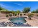 Backyard pool features a stone waterfall, mature landscaping, and a brick surround at 3152 E San Pedro Ct, Gilbert, AZ 85234