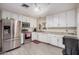 Well-lit kitchen features stainless steel appliances and white cabinetry at 3238 W Altadena Ave, Phoenix, AZ 85029
