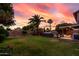 Beautiful backyard with green grass, palm trees, and a jacuzzi, perfect for outdoor relaxation and entertainment at 3377 W Grandview Rd, Phoenix, AZ 85053