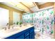 Bright bathroom with a double sink vanity and a colorful cactus themed shower curtain at 3377 W Grandview Rd, Phoenix, AZ 85053