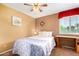 Cozy bedroom featuring a ceiling fan, a large bed and bright natural light at 3377 W Grandview Rd, Phoenix, AZ 85053