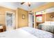 Bedroom features a ceiling fan, sliding mirror closet doors and ensuite bathroom at 3377 W Grandview Rd, Phoenix, AZ 85053