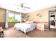 Bedroom with a large window, ceiling fan, and light pink bedside tables at 3377 W Grandview Rd, Phoenix, AZ 85053