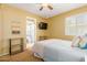 Cozy bedroom featuring carpeted floors, a ceiling fan, and an ensuite bathroom at 3377 W Grandview Rd, Phoenix, AZ 85053