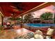 Inviting covered patio with ceiling fans overlooking pool, perfect for outdoor dining and relaxation at 3377 W Grandview Rd, Phoenix, AZ 85053