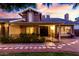 Charming home exterior with inviting front porch, manicured landscaping, and warm exterior lighting at 3377 W Grandview Rd, Phoenix, AZ 85053