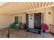 Welcoming front porch with colorful chairs and vibrant flowers, offering a charming entry to the home at 3377 W Grandview Rd, Phoenix, AZ 85053