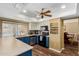 Bright kitchen with blue cabinetry, white countertops, and an adjacent dining area with pool view at 3377 W Grandview Rd, Phoenix, AZ 85053