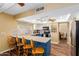Modern kitchen features a breakfast bar with seating, white cabinets, and stainless steel appliances at 3377 W Grandview Rd, Phoenix, AZ 85053