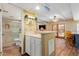 Charming living area with a wet bar, leading to a tiled bathroom and connected kitchen space at 3377 W Grandview Rd, Phoenix, AZ 85053