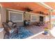 Inviting covered patio with ceiling fans, comfortable seating, and colorful rugs for outdoor relaxation and entertaining at 3377 W Grandview Rd, Phoenix, AZ 85053