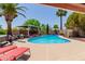A private backyard oasis with a sparkling pool, cabana, lush landscaping, and sun loungers for ultimate relaxation at 3377 W Grandview Rd, Phoenix, AZ 85053