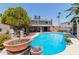 Inviting backyard oasis with a sparkling pool, hot tub and lush landscaping, perfect for outdoor entertaining at 3377 W Grandview Rd, Phoenix, AZ 85053