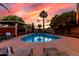 Beautiful backyard pool surrounded by lush landscaping, covered patio and palm trees, creating a serene oasis at 3377 W Grandview Rd, Phoenix, AZ 85053