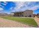 Beautiful backyard featuring low maintenance rock landscaping, a cozy covered patio, and new turf at 34834 N Surrey Ln, San Tan Valley, AZ 85140