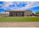 Expansive backyard with well-kept turf, rock landscaping, and a covered patio, great for outdoor activities at 34834 N Surrey Ln, San Tan Valley, AZ 85140