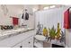 Cozy bathroom featuring granite countertops and decorative cactus shower curtain at 34834 N Surrey Ln, San Tan Valley, AZ 85140