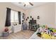 Spacious bedroom filled with fun decorations and a large window for natural light at 34834 N Surrey Ln, San Tan Valley, AZ 85140