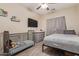 Bright bedroom with a crib, television and wood flooring at 34834 N Surrey Ln, San Tan Valley, AZ 85140