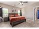 A bedroom featuring a ceiling fan, tiled flooring, and a gray wood-trim bed frame at 34834 N Surrey Ln, San Tan Valley, AZ 85140
