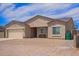 Single-story home featuring a two-car garage, low-maintenance landscaping, and a welcoming front porch at 34834 N Surrey Ln, San Tan Valley, AZ 85140