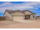 Single-story home with a two-car garage, desert landscaping, and long driveway at 34834 N Surrey Ln, San Tan Valley, AZ 85140