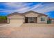 Charming single-story home featuring a two-car garage, low-maintenance landscaping, and a welcoming front porch at 34834 N Surrey Ln, San Tan Valley, AZ 85140