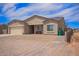 Single-story home featuring a two-car garage, low-maintenance landscaping, and a welcoming front porch at 34834 N Surrey Ln, San Tan Valley, AZ 85140