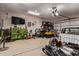 Organized garage space featuring a variety of tools, sports equipment, and storage solutions at 34834 N Surrey Ln, San Tan Valley, AZ 85140