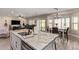 A close shot of the kitchen featuring granite countertops, stainless appliances, white cabinets, and breakfast bar seating at 34834 N Surrey Ln, San Tan Valley, AZ 85140