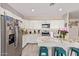The kitchen features stainless steel appliances, white cabinets, granite countertops, and a breakfast bar at 34834 N Surrey Ln, San Tan Valley, AZ 85140