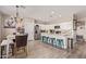 Bright eat-in kitchen boasts white cabinets, stainless appliances, granite counters, and breakfast bar seating at 34834 N Surrey Ln, San Tan Valley, AZ 85140