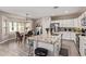 Bright kitchen featuring a breakfast bar, granite countertops, stainless steel appliances, and a dining area at 34834 N Surrey Ln, San Tan Valley, AZ 85140