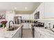 Beautiful kitchen with granite counters, white cabinets, stainless steel appliances, and a stainless sink at 34834 N Surrey Ln, San Tan Valley, AZ 85140