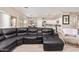Open-concept living room featuring wood-look tile, plush seating, and seamless flow to the kitchen at 34834 N Surrey Ln, San Tan Valley, AZ 85140