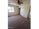 Bedroom featuring an updated ceiling fan, closet with sliding doors, and a window for natural light at 3779 E Sweetwater Ave, Phoenix, AZ 85032