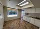 Bright kitchen with stainless steel appliances, large window, and tiled floor at 3779 E Sweetwater Ave, Phoenix, AZ 85032