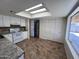 Open kitchen with a skylight, tiled floors, and stainless steel refrigerator at 3779 E Sweetwater Ave, Phoenix, AZ 85032