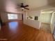 Open concept living space features wood floors, brick fireplace, and access to the kitchen at 3779 E Sweetwater Ave, Phoenix, AZ 85032