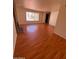 Large living room with wood floors, brick fireplace, and large window at 3779 E Sweetwater Ave, Phoenix, AZ 85032
