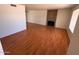 Bright and airy living room features a brick fireplace and wood floors at 3779 E Sweetwater Ave, Phoenix, AZ 85032