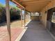 Spacious covered patio with concrete flooring, ideal for outdoor living and entertaining in a landscaped backyard at 3779 E Sweetwater Ave, Phoenix, AZ 85032
