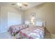 Comfortable bedroom with twin beds, featuring a ceiling fan, closet, and tiled floor at 3830 E Lakewood Pkwy # 1051, Phoenix, AZ 85048