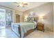 Comfortable bedroom featuring a queen bed, ceiling fan, and sliding glass door to outdoor space at 3830 E Lakewood Pkwy # 1051, Phoenix, AZ 85048
