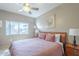 Cozy bedroom with a ceiling fan, plush bedding, and a window offering plenty of natural light at 3830 E Lakewood Pkwy # 1051, Phoenix, AZ 85048