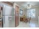 Cozy dining area featuring a ceiling fan, tile flooring, and a large window for natural lighting at 3830 E Lakewood Pkwy # 1051, Phoenix, AZ 85048