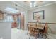 Well-lit dining area adjacent to kitchen offers wood table, seating for four and stainless steel appliances at 3830 E Lakewood Pkwy # 1051, Phoenix, AZ 85048