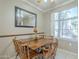Bright dining room featuring a large window and a decorative mirror, creating a welcoming space at 3830 E Lakewood Pkwy # 1051, Phoenix, AZ 85048